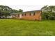 A charming brick home with black shutters and a well-maintained lawn at 1019 Carmel Dr, Gastonia, NC 28056