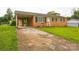 Exterior view of a brick home with covered carport and concrete driveway at 1019 Carmel Dr, Gastonia, NC 28056