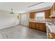 Kitchen with wood cabinets, updated floors and neutral wall color at 1019 Carmel Dr, Gastonia, NC 28056