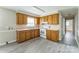 A bright kitchen featuring wood cabinets, updated floor and white appliances at 1019 Carmel Dr, Gastonia, NC 28056