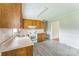 Bright kitchen featuring wood cabinets, updated floor and white appliances at 1019 Carmel Dr, Gastonia, NC 28056
