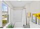 Bright bathroom featuring tub and shower, white vanity, and large window with natural light at 11195 Argosy Dr # 1098, Lancaster, SC 29720