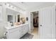 Bright bathroom featuring a double vanity, large mirror, and access to a walk-in closet at 11195 Argosy Dr # 1098, Lancaster, SC 29720