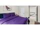 This cozy bedroom has a bed with purple comforter, an art piece on the wall, and a white door at 11195 Argosy Dr # 1098, Lancaster, SC 29720