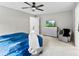 Neutral bedroom boasts a ceiling fan, a mounted TV, gray chair, and carpeted floors at 11195 Argosy Dr # 1098, Lancaster, SC 29720