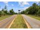 Inviting entrance to Edgewater featuring lush landscaping, community sign, and a distinctive architectural tower at 11195 Argosy Dr # 1098, Lancaster, SC 29720