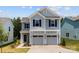 Charming two-story home featuring a two-car garage, light blue siding and a welcoming entrance at 11195 Argosy Dr # 1098, Lancaster, SC 29720