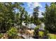 Serene lake view property surrounded by lush trees, featuring a private dock and outdoor living space at 11195 Argosy Dr # 1098, Lancaster, SC 29720