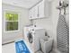 Functional laundry room with washer, dryer, upper cabinets, and a window at 11195 Argosy Dr # 1098, Lancaster, SC 29720