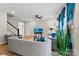 Open-concept living area boasts hardwood floors, modern decor, blue accents, and a stairwell on the left at 11195 Argosy Dr # 1098, Lancaster, SC 29720
