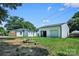 Spacious backyard featuring grass, fire pit, detached garage, and additional outbuilding at 1122 Oconee Ave, Rock Hill, SC 29732