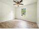 This bedroom features a ceiling fan, natural light, and beautiful, light-colored wood floors at 1122 Oconee Ave, Rock Hill, SC 29732