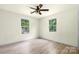 Bright bedroom featuring a modern ceiling fan, new laminate flooring, and natural light from the two windows at 1122 Oconee Ave, Rock Hill, SC 29732