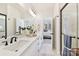 Modern bathroom with a white vanity, large mirror, sleek black fixtures, and glass enclosed shower at 1223 E 16Th St # 13, Charlotte, NC 28205