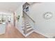 Hallway with hardwood floors, staircase, and access to living areas at 1223 E 16Th St # 13, Charlotte, NC 28205