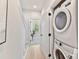 Convenient laundry area with stacked washer and dryer, wood floors, and a view to another room at 1223 E 16Th St # 13, Charlotte, NC 28205