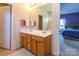 Bright bathroom featuring a double vanity and a view into a bedroom with purple walls at 1226 Rising Oak Dr, Charlotte, NC 28206