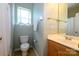 Cozy bathroom featuring a single sink vanity, toilet, and shower with neutral color palette at 1226 Rising Oak Dr, Charlotte, NC 28206