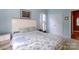 Inviting bedroom with soft lighting, carpet, and a large window with ample closet space at 1226 Rising Oak Dr, Charlotte, NC 28206