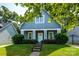 Charming home featuring a covered porch and landscaped front yard with manicured shrubbery at 1226 Rising Oak Dr, Charlotte, NC 28206