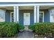 Inviting front porch with white columns and neatly trimmed shrubs in decorative pots at 1226 Rising Oak Dr, Charlotte, NC 28206