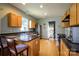Well-lit kitchen featuring stainless steel appliances, breakfast bar and hardwood floors at 1226 Rising Oak Dr, Charlotte, NC 28206