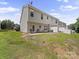 Townhome backyard featuring a small patio, grass, and some trees at 12415 Stratfield Place Cir, Pineville, NC 28134