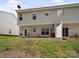 Townhome backyard with small patio, grass, and trees in view at 12415 Stratfield Place Cir, Pineville, NC 28134