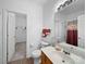 Bathroom featuring a large mirror, toilet, vanity, and a view into the walk-in closet and the shower at 12415 Stratfield Place Cir, Pineville, NC 28134