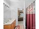 Bathroom featuring a large mirror, vanity, and shower-bathtub combination with a view into the bedroom at 12415 Stratfield Place Cir, Pineville, NC 28134