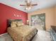Comfortable bedroom features a ceiling fan, window, and color accent wall at 12415 Stratfield Place Cir, Pineville, NC 28134