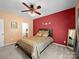 Cozy bedroom with ceiling fan, accent wall, and view into the en suite bathroom at 12415 Stratfield Place Cir, Pineville, NC 28134