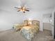 Bedroom with two beds, a ceiling fan, and a lamp at 12415 Stratfield Place Cir, Pineville, NC 28134