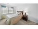 Bedroom features a window, a lamp, and a bed with decorative pillows at 12415 Stratfield Place Cir, Pineville, NC 28134