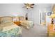 Charming bedroom featuring twin beds, ceiling fan and ensuite bathroom entrance at 12415 Stratfield Place Cir, Pineville, NC 28134