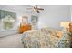 Cozy bedroom with twin beds, neutral carpet, ceiling fan and window at 12415 Stratfield Place Cir, Pineville, NC 28134