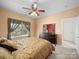 Inviting bedroom featuring a ceiling fan, large window and dresser at 12415 Stratfield Place Cir, Pineville, NC 28134