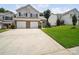 Exterior view of a two-story townhome with a two-car garage and well-kept lawn at 12415 Stratfield Place Cir, Pineville, NC 28134