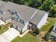 Aerial view of a two-story townhome with a two-car garage and manicured landscaping at 12415 Stratfield Place Cir, Pineville, NC 28134