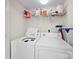 Efficient laundry area with appliances and shelving for storage solutions in this functional space at 12415 Stratfield Place Cir, Pineville, NC 28134