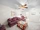 Cozy living room with sofas, a ceiling fan, and a glass-topped coffee table at 12415 Stratfield Place Cir, Pineville, NC 28134