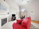 Bright living room featuring high ceilings, a fireplace, a large window, and comfortable seating at 12415 Stratfield Place Cir, Pineville, NC 28134