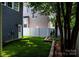 Spacious backyard with artificial turf, a white fence, and landscaped garden beds at 138 Blandina Ct, Fort Mill, SC 29708