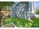 View of a backyard featuring an artificial lawn and the side of a blue home at 138 Blandina Ct, Fort Mill, SC 29708