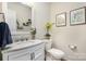Half bathroom with a marble vanity, decorative mirror, and updated fixtures at 138 Blandina Ct, Fort Mill, SC 29708
