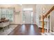 Spacious foyer with gleaming hardwood floors, a staircase with a wooden handrail, and a view of the front door at 138 Blandina Ct, Fort Mill, SC 29708