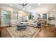 Spacious living room with a sectional sofa, dining area, hardwood floors, and lots of natural light at 138 Blandina Ct, Fort Mill, SC 29708