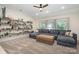 Spacious living room with a large couch, carpeted floors, and custom shelving with plenty of natural light at 138 Blandina Ct, Fort Mill, SC 29708
