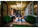 Cozy covered patio with a hot tub, heater, comfortable seating, outdoor lights, and manicured landscaping at 138 Blandina Ct, Fort Mill, SC 29708