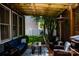Cozy covered patio with a grill, heater, comfortable seating, outdoor lights, and manicured landscaping at 138 Blandina Ct, Fort Mill, SC 29708